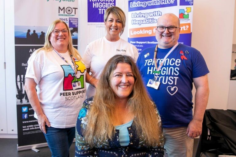 Lynne Short with long hair before the Big Shave Off with Terrence Higgins Trust staff