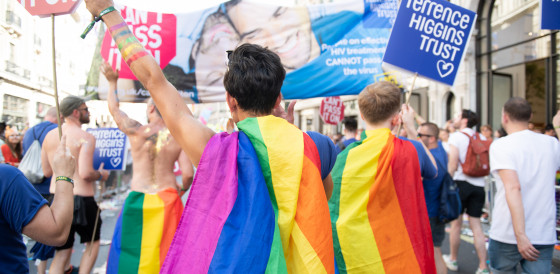 Pride marchers wearing rainbow cloaks Pride marchers wearing rainbow cloaks