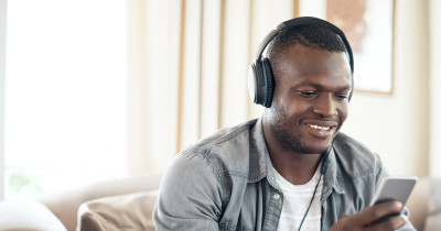 Man with headphones looking at his mobile phone