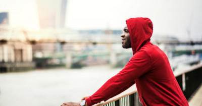 Sporty person looking out across river