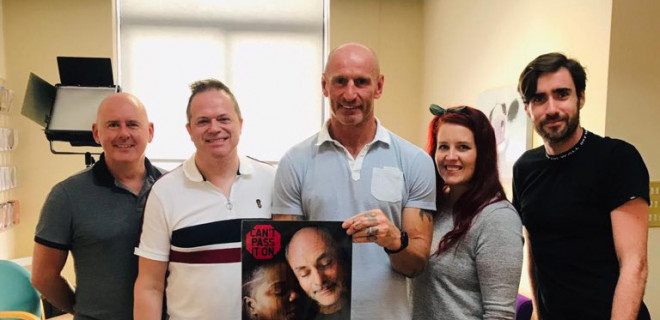 Gareth Thomas holding Can't Pass It On poster with THT staff