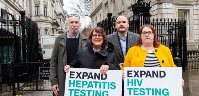 Stuart Smith, Vanessa Hebditch, Richard Angell and Deborah Gold holding signs saying 'Expand hepatitis testing in A&Es' and 'Expand HIV testing in A&Es' outside Downing Street. 