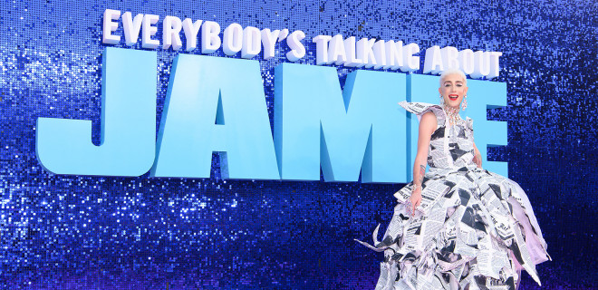 Jamie Campbell in front of the Everybody's Talking About Jamie logo