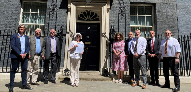 Representatives of multiple organisations outside 10 Downing Street with letter to Prime Minister