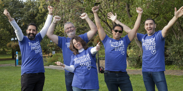 Group posing in THT shirts in a park